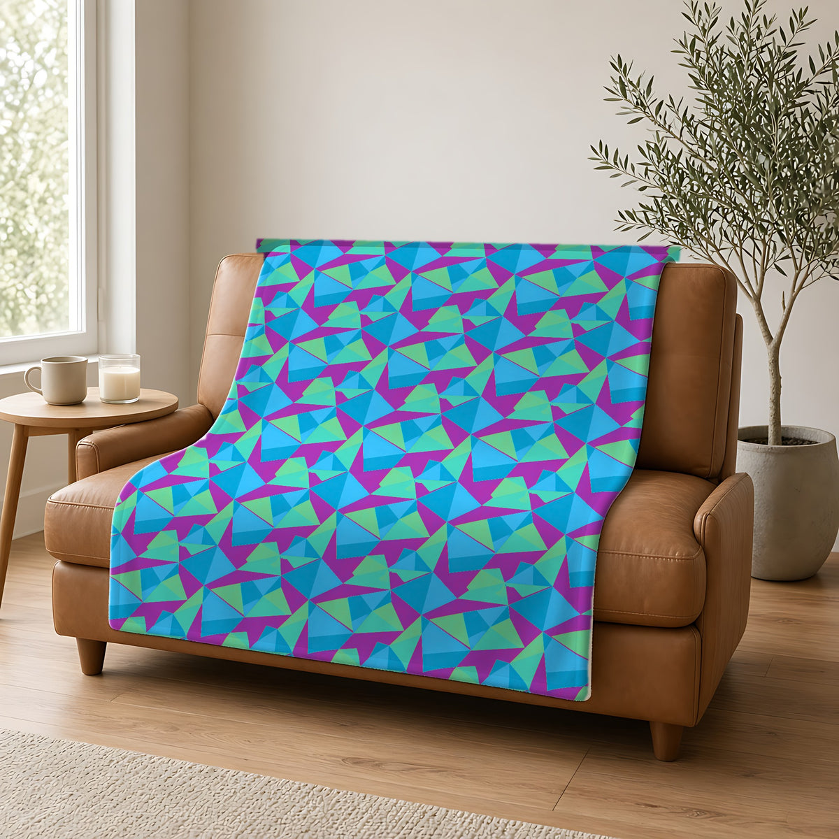 Faceted Panels Sherpa Fleece Blanket draped over a caramel leather sofa