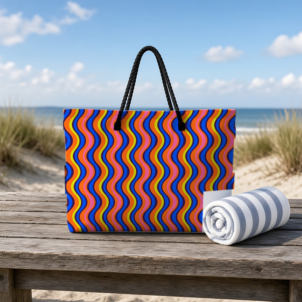 Warped Circus Stripes Weekender Tote Bag on a rustic table by the beach