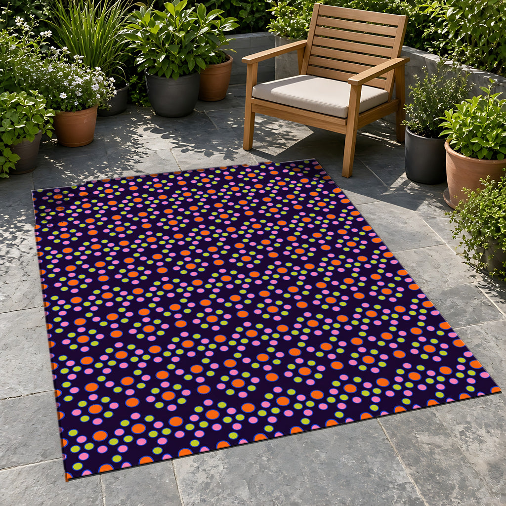 Bulging Dot Grid Outdoor Rug on a stone patio with potted plants