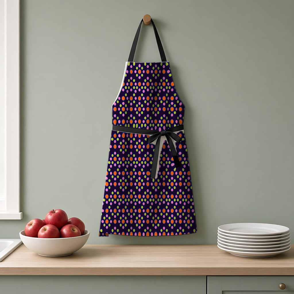 Bulging Dot Grid Apron hanging on a sage-green kitchen wall