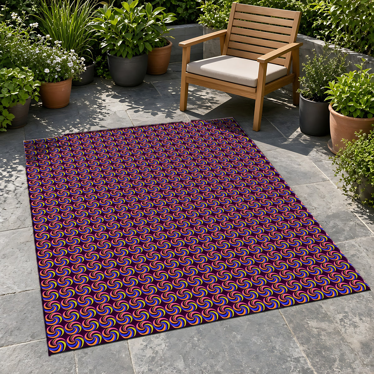 Spiral Stripe Swirls Outdoor Rug on a stone patio with potted plants
