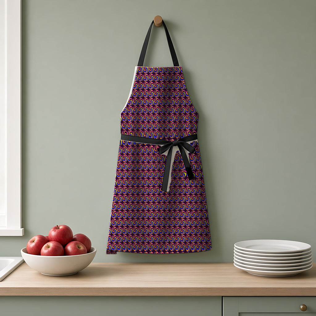 Spiral Stripe Swirls Apron hanging on a sage-green kitchen wall