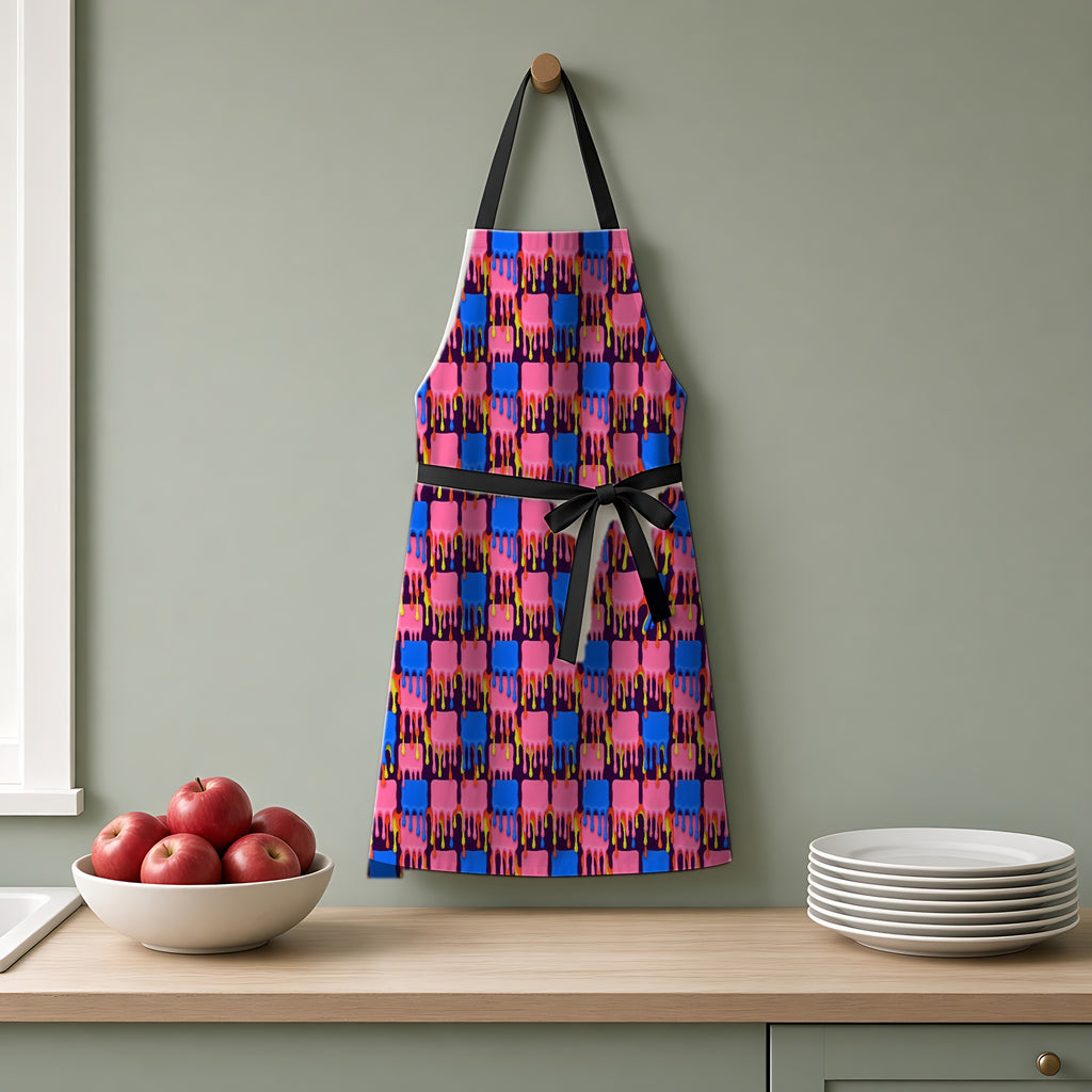 Melting Checkerboard Apron hanging on a sage-green kitchen wall