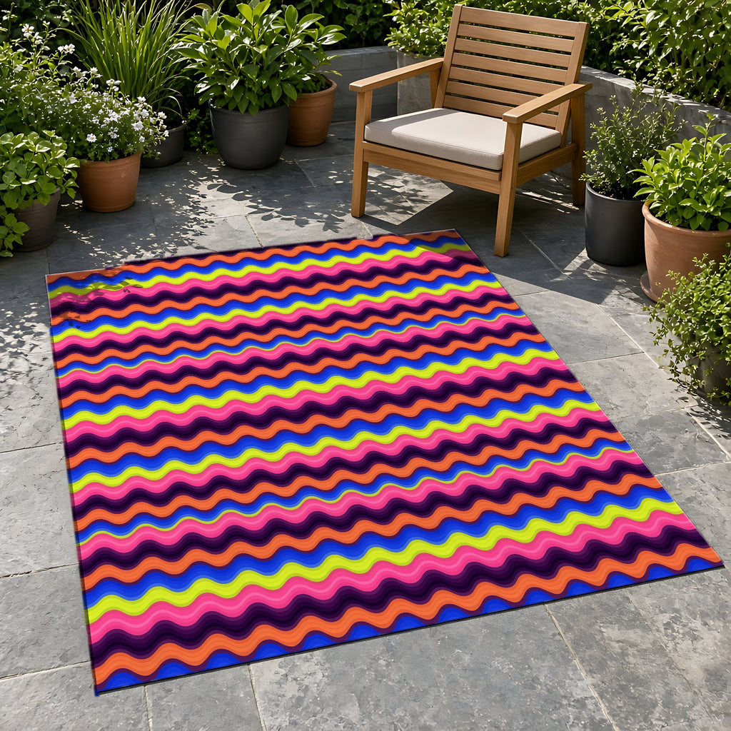 Bold Wave Stripes Outdoor Rug on a stone patio with potted plants
