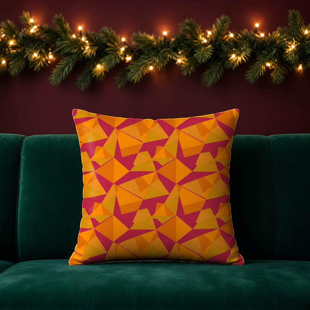 Faceted Gold Panels Faux Suede Cushion in the Cranberry Spice palette, on an emerald sofa in a festive room with a garland and fairy lights