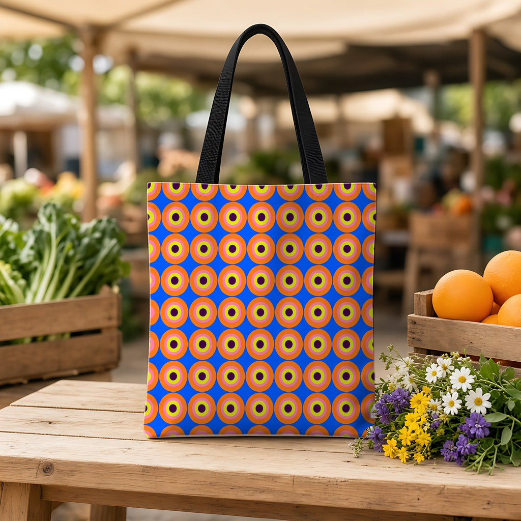Pop Target Dots Weekender Tote Bag on a wooden bench at a farmers market