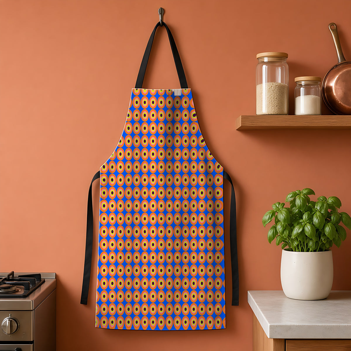 Pop Target Dots Apron hanging on a terracotta kitchen wall
