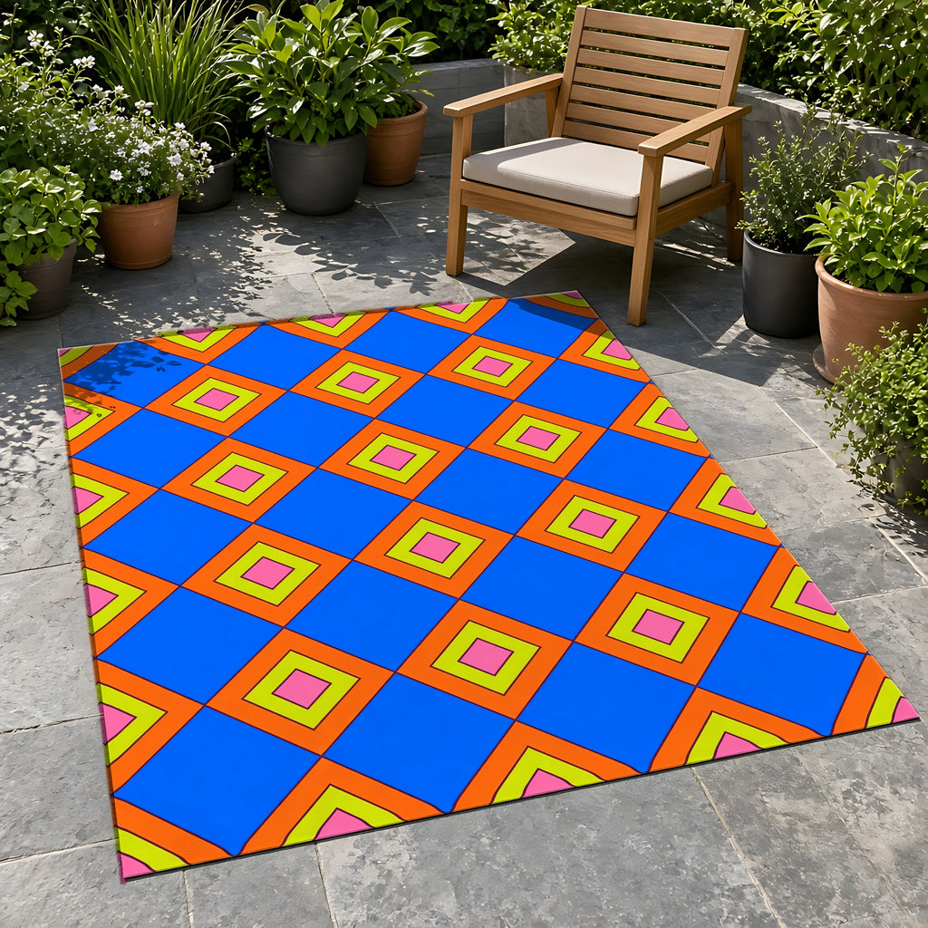 Pop Diamond Checks Outdoor Rug on a stone patio with potted plants
