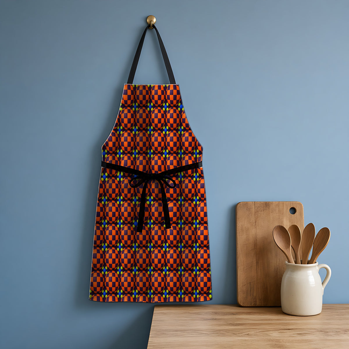 Checker Bulge Apron hanging in a blue kitchen
