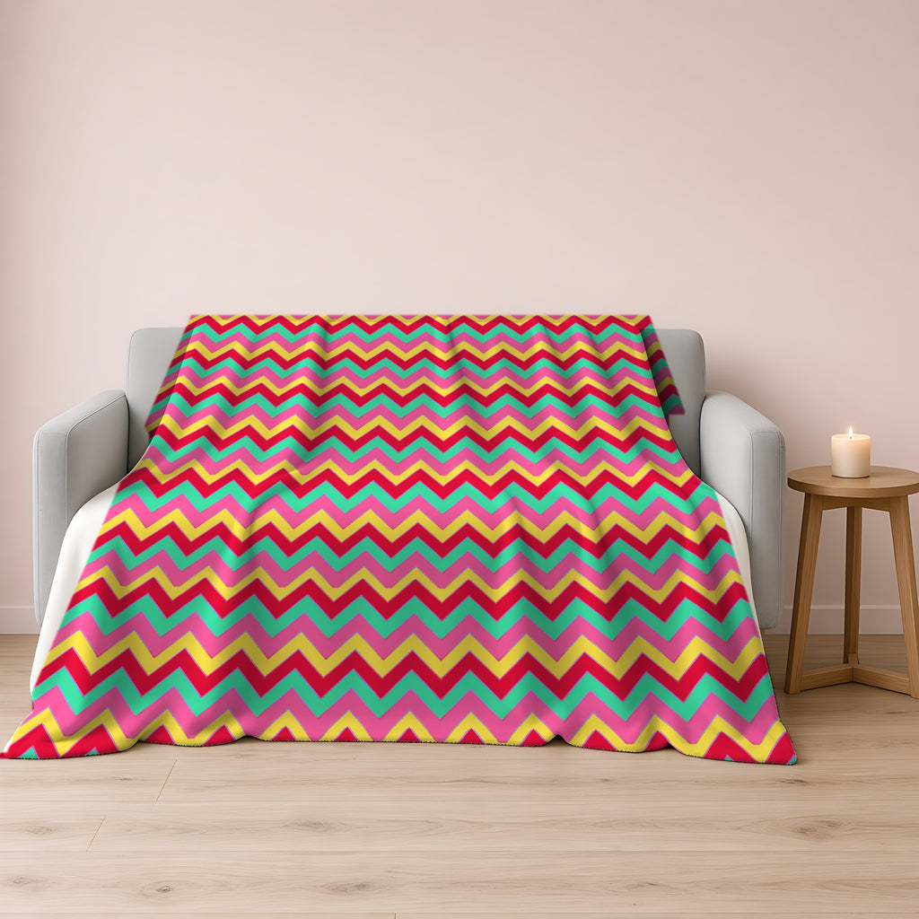 Jewel Chevron Bands Sherpa Fleece Blanket draped over a grey sofa