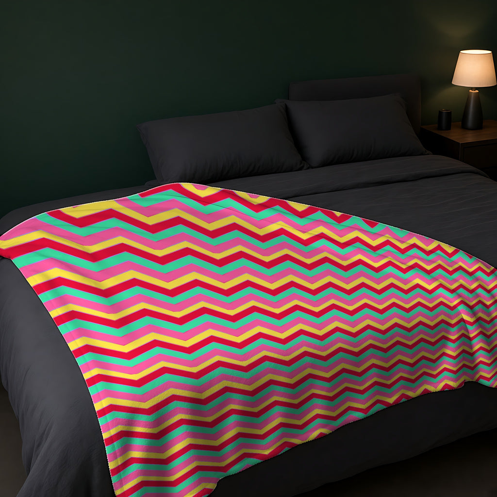 Jewel Chevron Bands Sherpa Fleece Blanket across the foot of a dark bed