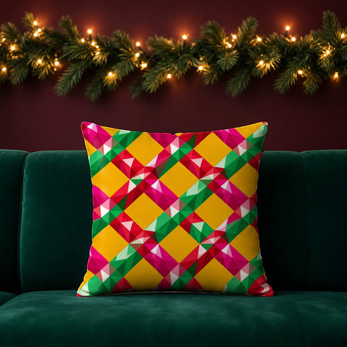 Big Jewel Prism Weave II faux suede cushion in the Christmas Jewel Bright palette, on an emerald sofa in a festive room with a garland and fairy lights