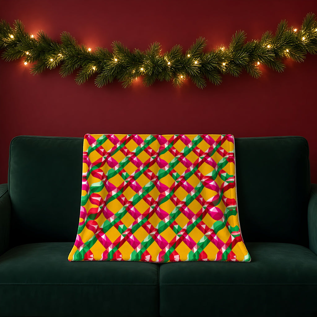 Big Jewel Prism Weave II sherpa fleece blanket in the Christmas Jewel Bright palette, draped over a green sofa in a festive room with a garland and fairy lights