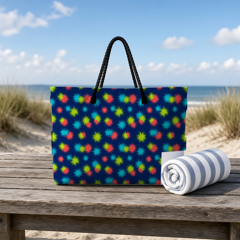 Dye Drop Spread Weekender Tote Bag on a rustic table by the beach