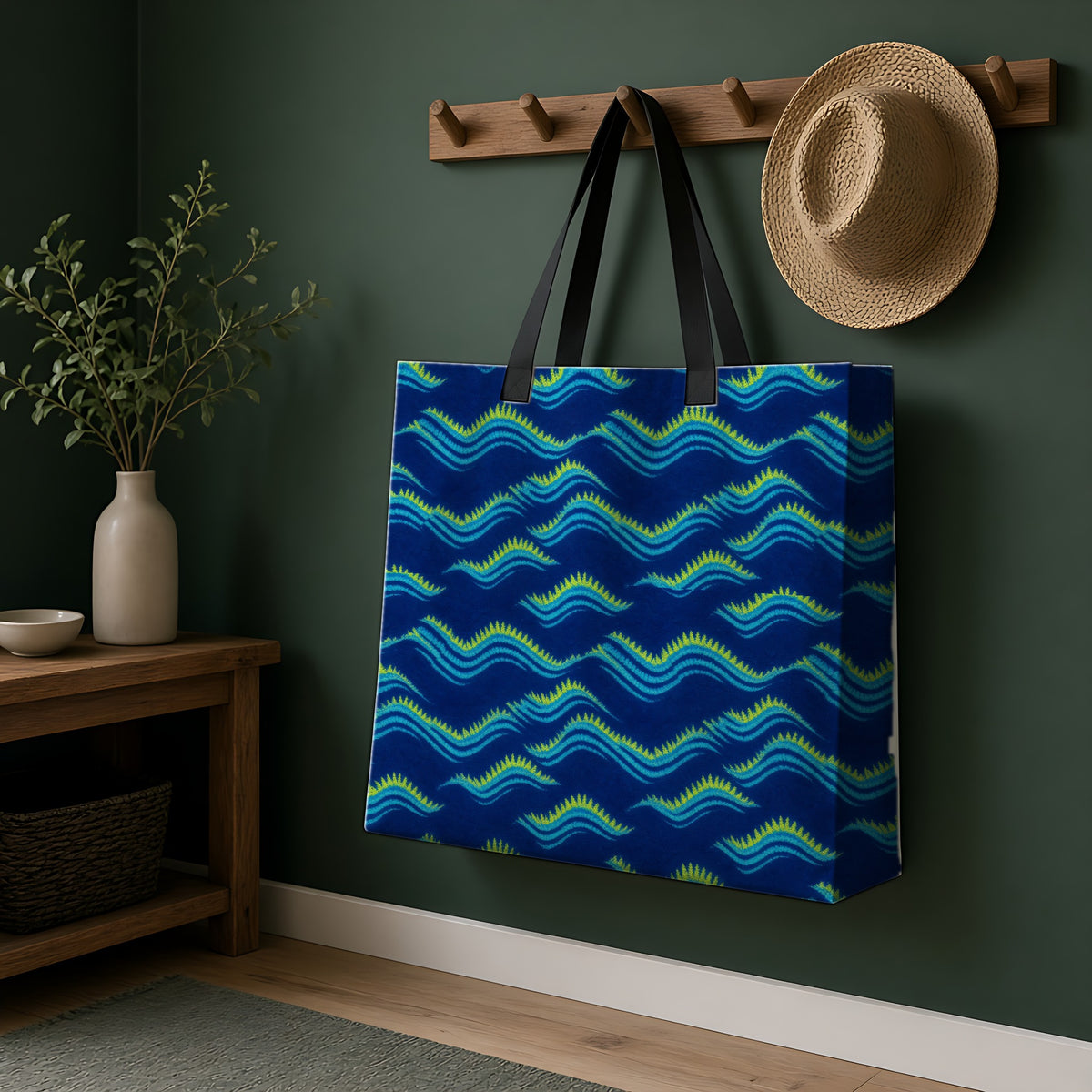 Pleat Wave Dye Weekender Tote Bag hanging on a peg rail in a green hallway