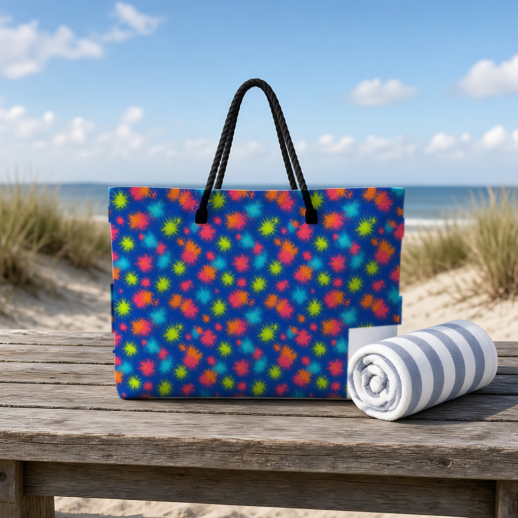 Speckle Bleed Weekender Tote Bag on a rustic table by the beach