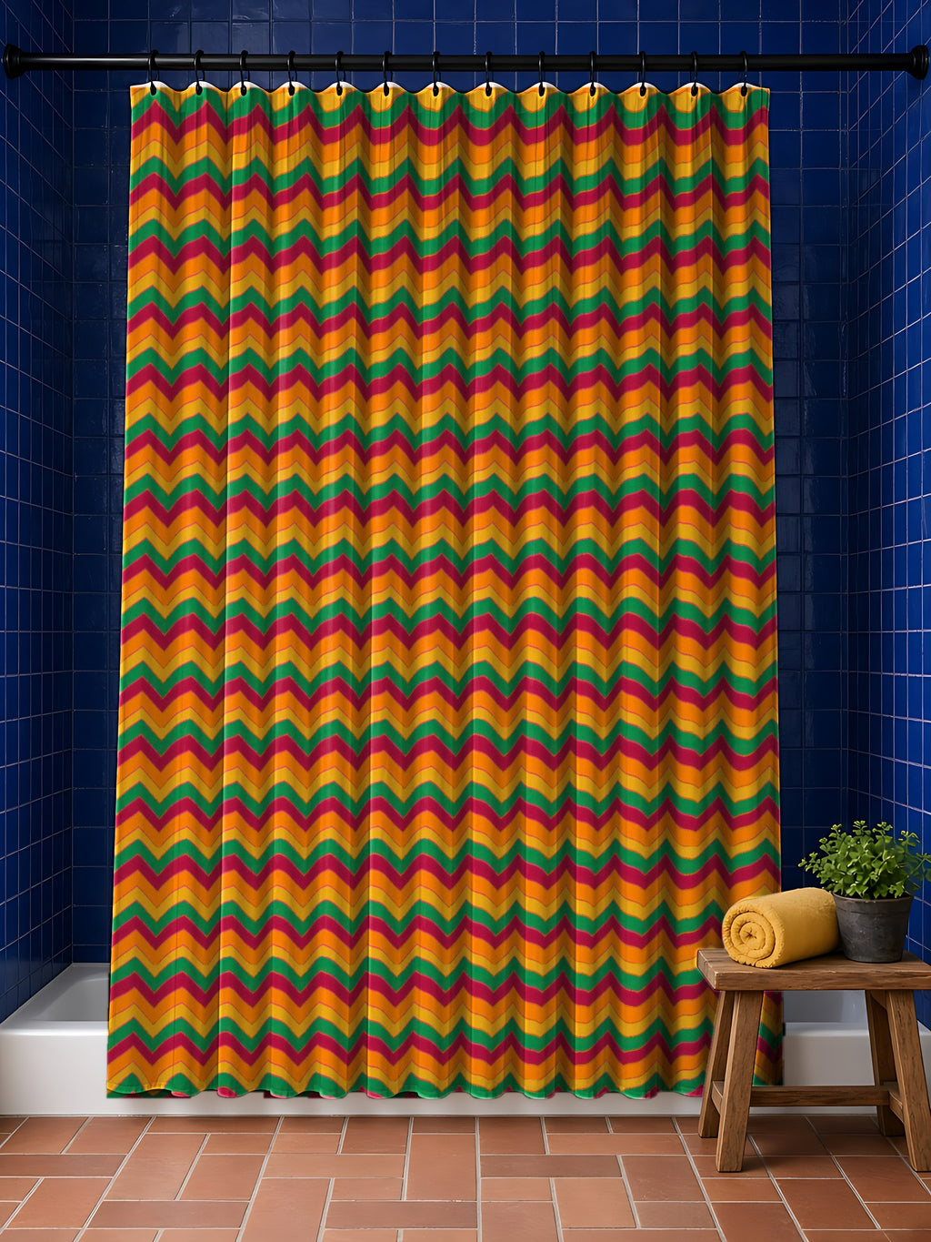 Jewel Chevron Bands Shower Curtain in the Cranberry Spice palette, hanging in a bathroom with cobalt tiles and a terracotta floor