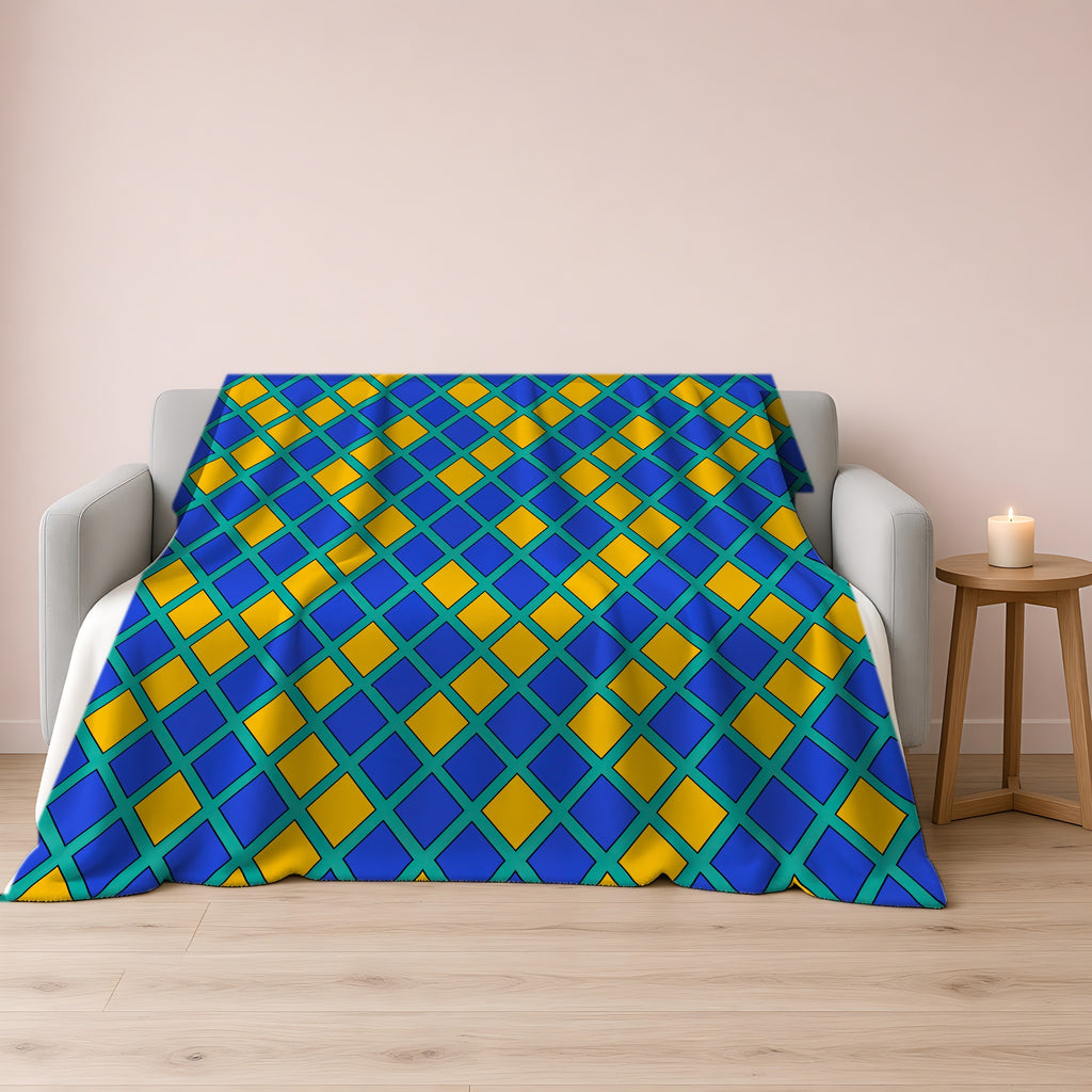 Harlequin Gold Grid Sherpa Fleece Blanket draped over a grey sofa