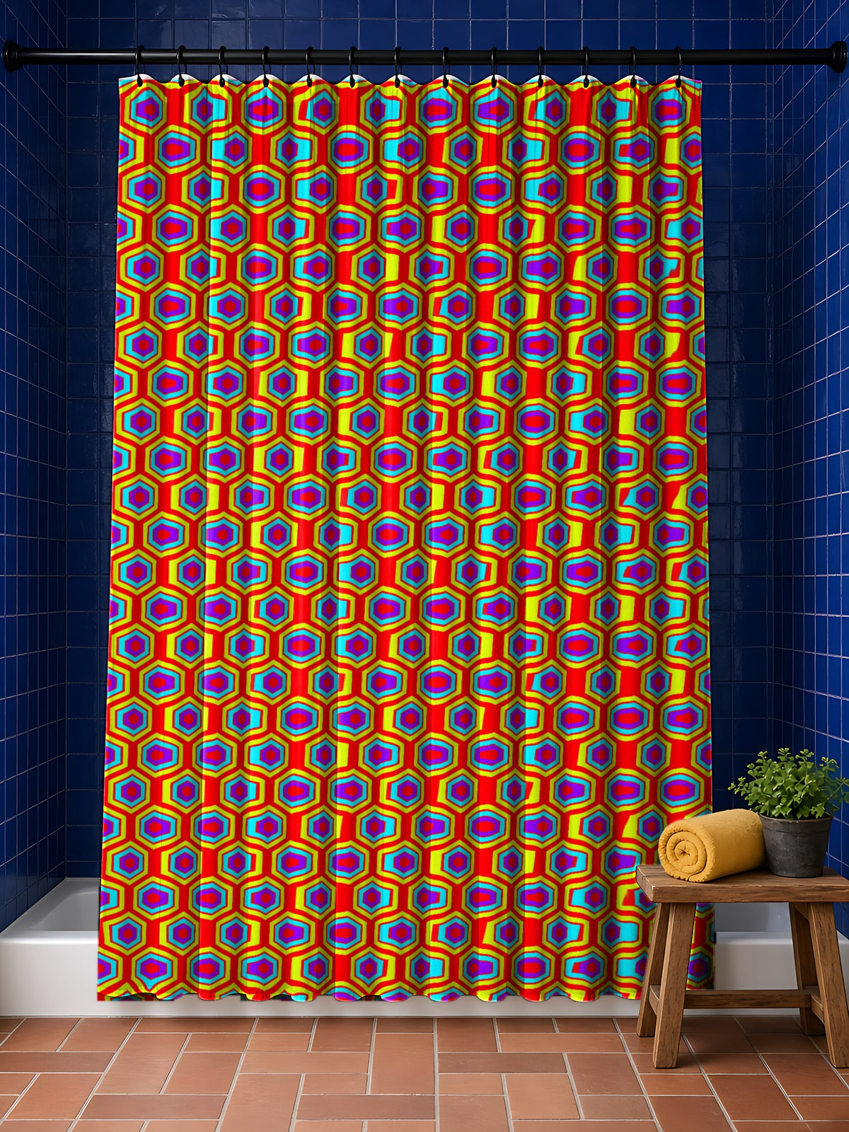 Concentric Hexagon Ripple shower curtain in the Chromatic Ripple palette, hanging in a bathroom with cobalt tiles and a terracotta floor