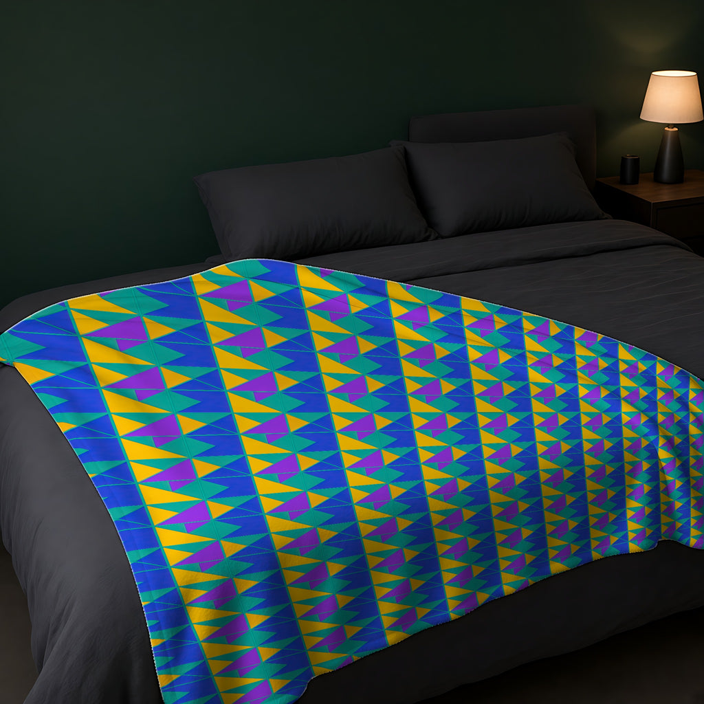 Jewel Block Quilt Sherpa Fleece Blanket across the foot of a dark bed
