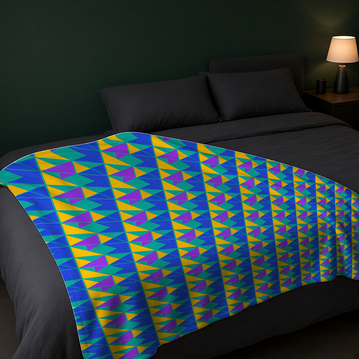 Jewel Block Quilt Sherpa Fleece Blanket across the foot of a dark bed