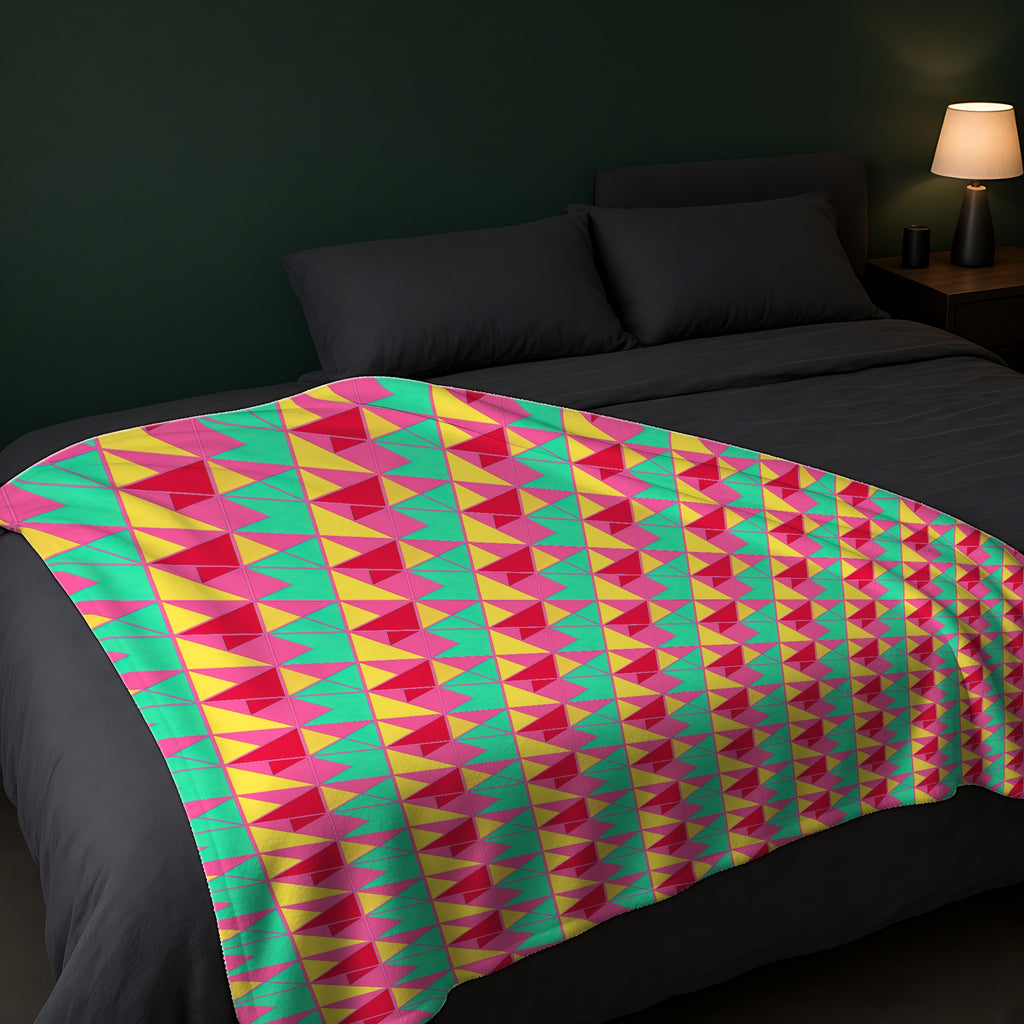 Jewel Block Quilt Sherpa Fleece Blanket across the foot of a dark bed