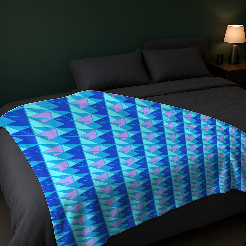 Jewel Block Quilt Sherpa Fleece Blanket across the foot of a dark bed