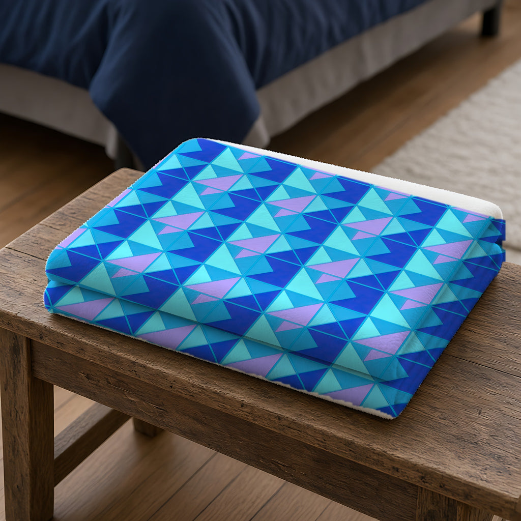 Jewel Block Quilt Sherpa Fleece Blanket folded on a wooden bench