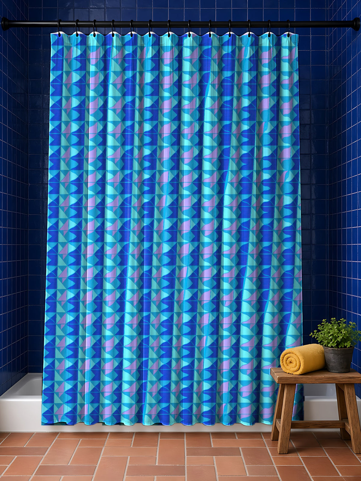 Jewel Block Quilt Shower Curtain in the Ice Jewel palette, hanging in a bathroom with cobalt tiles and a terracotta floor