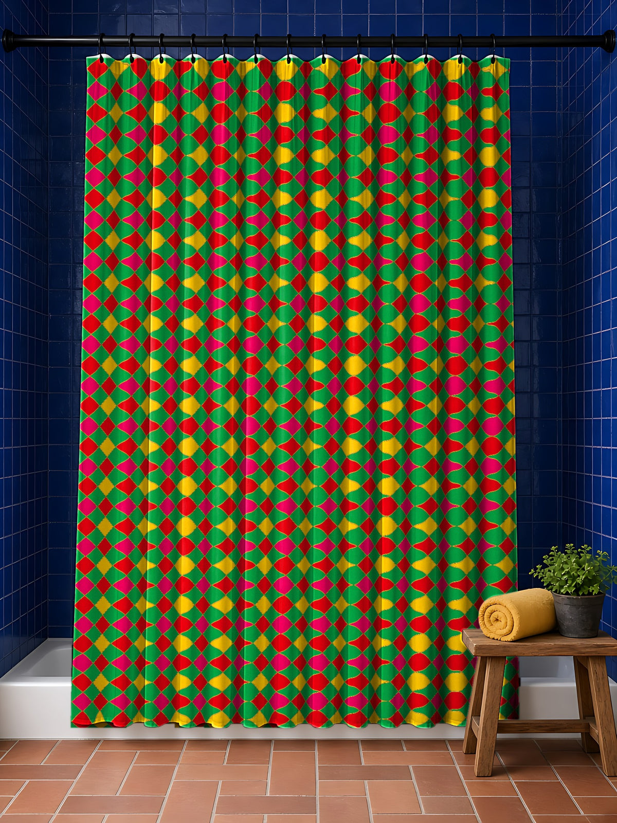 Jewel Harlequin Check shower curtain in the Festive Jewel Bright palette, hanging in a bathroom with cobalt tiles and a terracotta floor