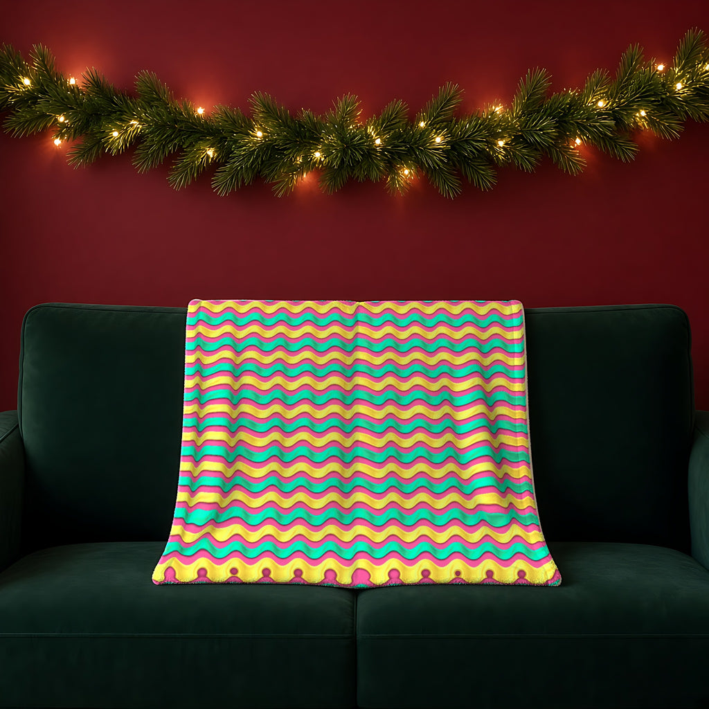Satin Wave Bands Sherpa Fleece Blanket in the Candy Christmas palette, draped over a green sofa in a festive room with a garland and fairy lights