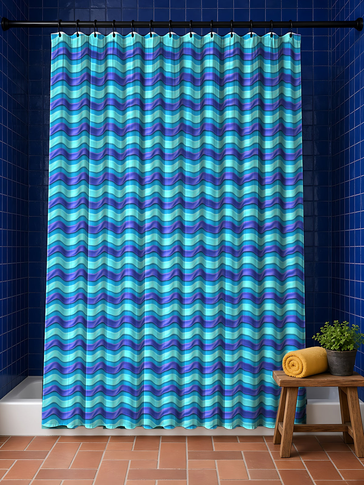 Satin Wave Bands Shower Curtain in the Ice Jewel palette, hanging in a bathroom with cobalt tiles and a terracotta floor