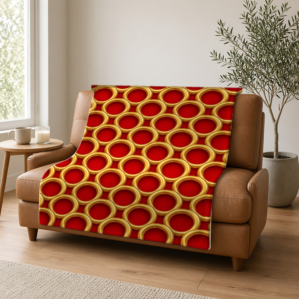 Big Gold Ring Weave Sherpa Fleece Blanket draped over a caramel leather sofa