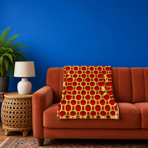 Big Gold Ring Weave sherpa fleece blanket in the Christmas Jewel Bright palette, draped over a rust sofa against a cobalt wall