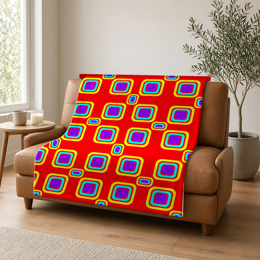 Big Ripple Squares Sherpa Fleece Blanket draped over a caramel leather sofa