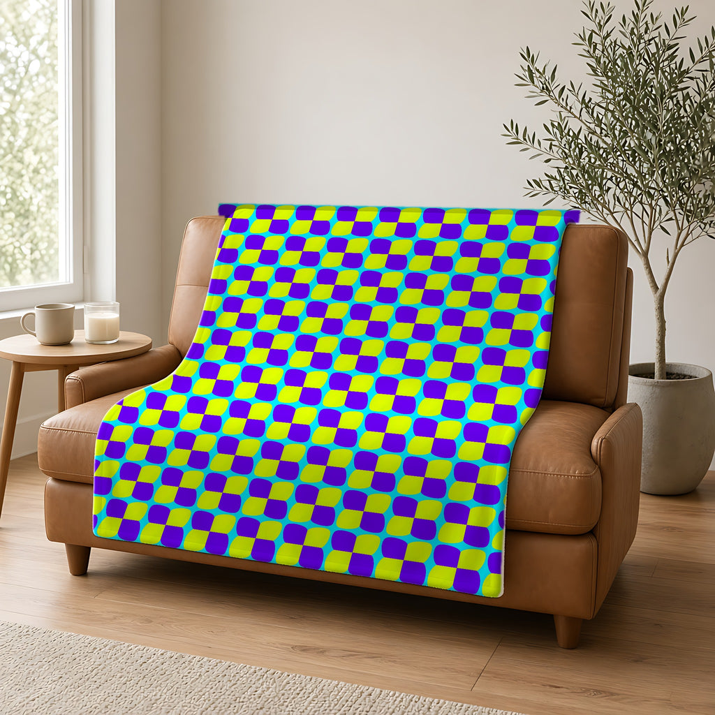 Bold Bulge Checker Sherpa Fleece Blanket draped over a caramel leather sofa