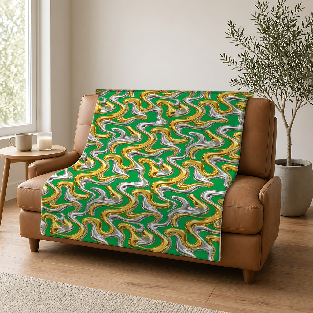Broad Melting Gold Ribbons Sherpa Fleece Blanket draped over a caramel leather sofa