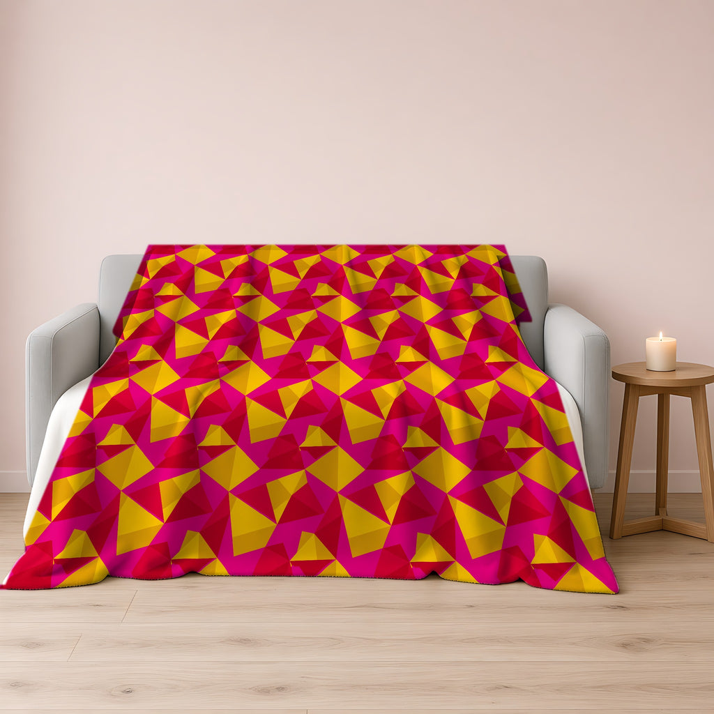 Faceted Gold Panels Sherpa Fleece Blanket draped over a grey sofa