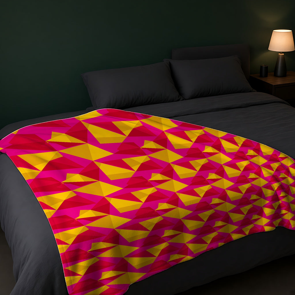 Faceted Gold Panels Sherpa Fleece Blanket across the foot of a dark bed