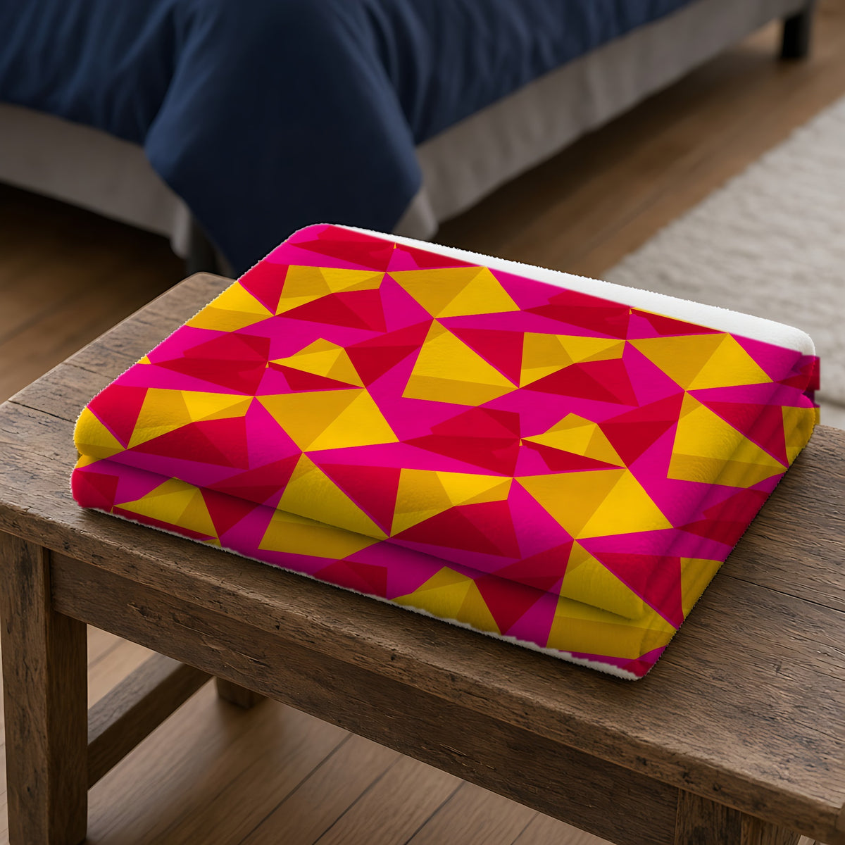 Faceted Gold Panels Sherpa Fleece Blanket folded on a wooden bench