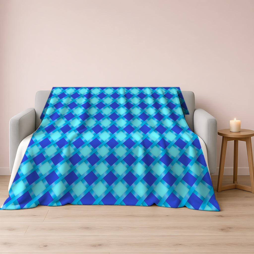 Broad Diamond Trellis Sherpa Fleece Blanket draped over a grey sofa