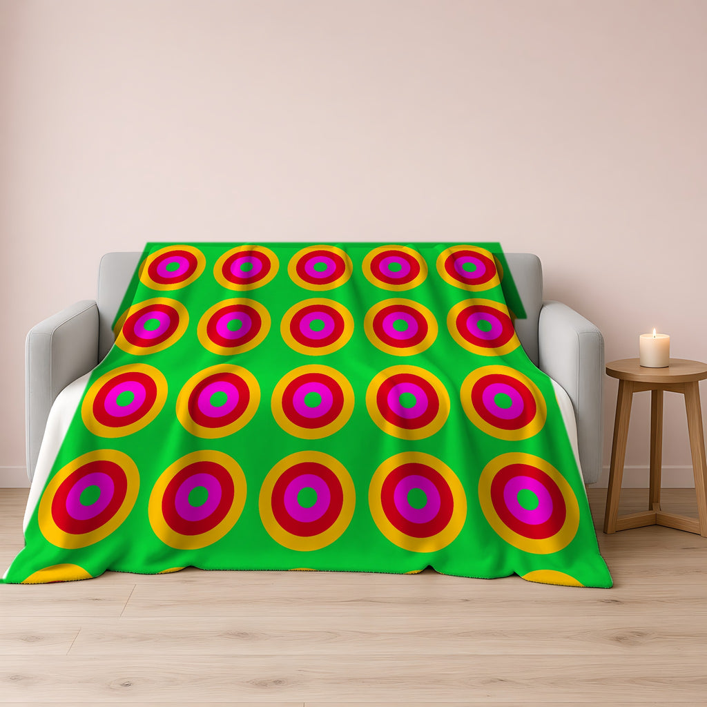 Giant Op-Art Jewel Rings Sherpa Fleece Blanket draped over a grey sofa