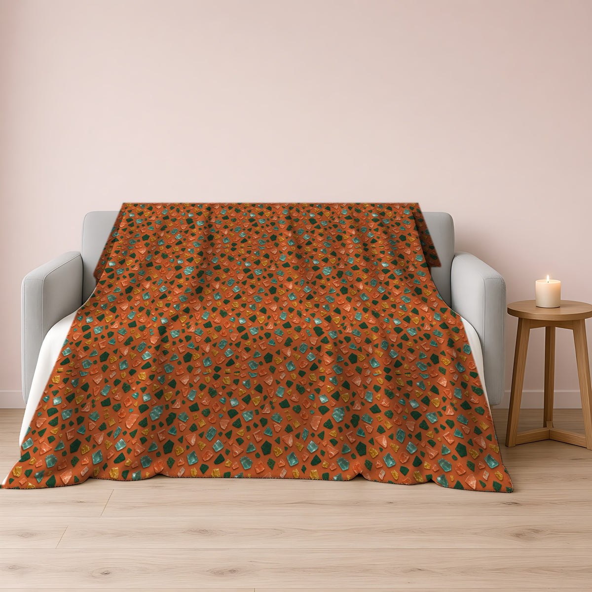 Glass Chip Sheen Sherpa Fleece Blanket draped over a grey sofa