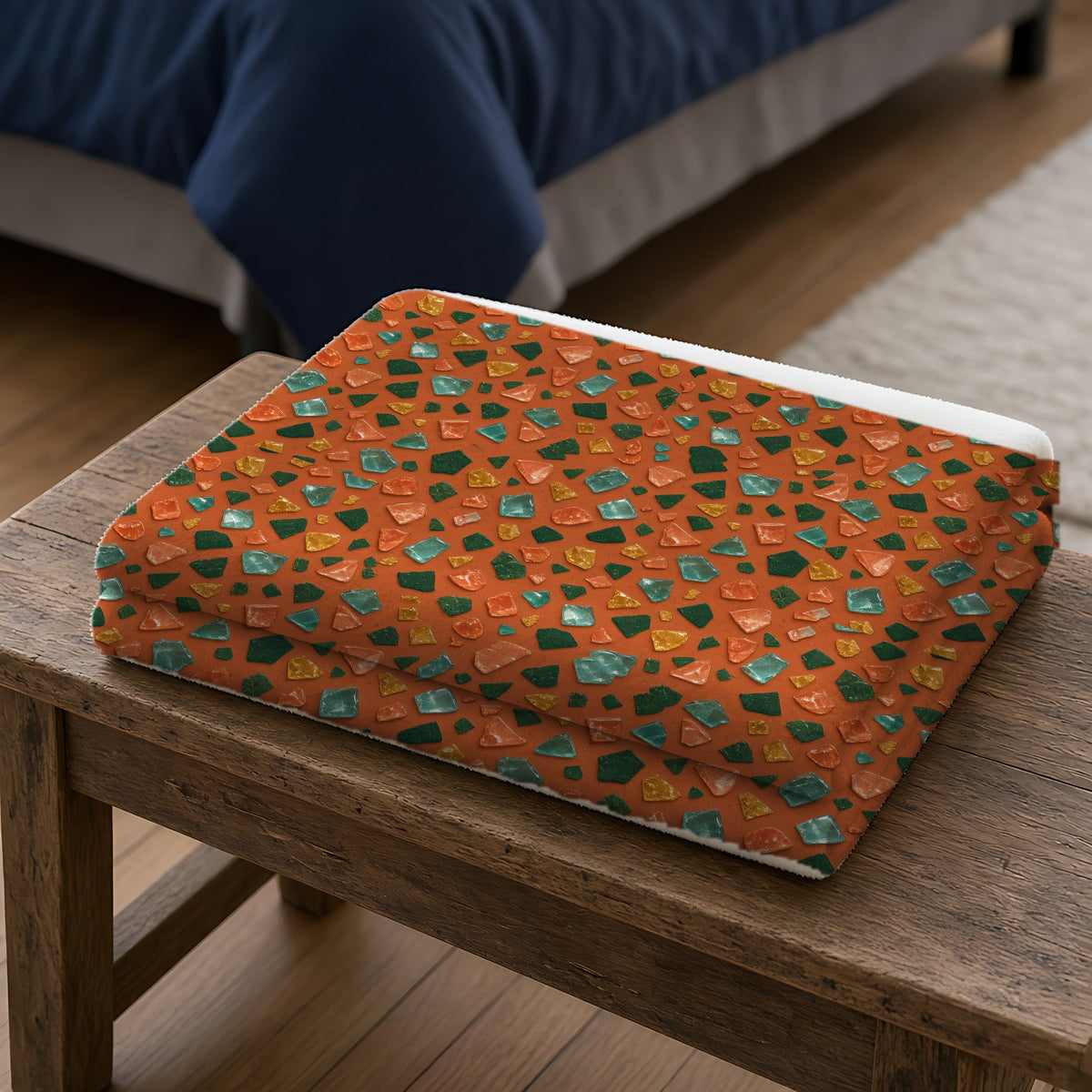 Glass Chip Sheen Sherpa Fleece Blanket folded on a wooden bench