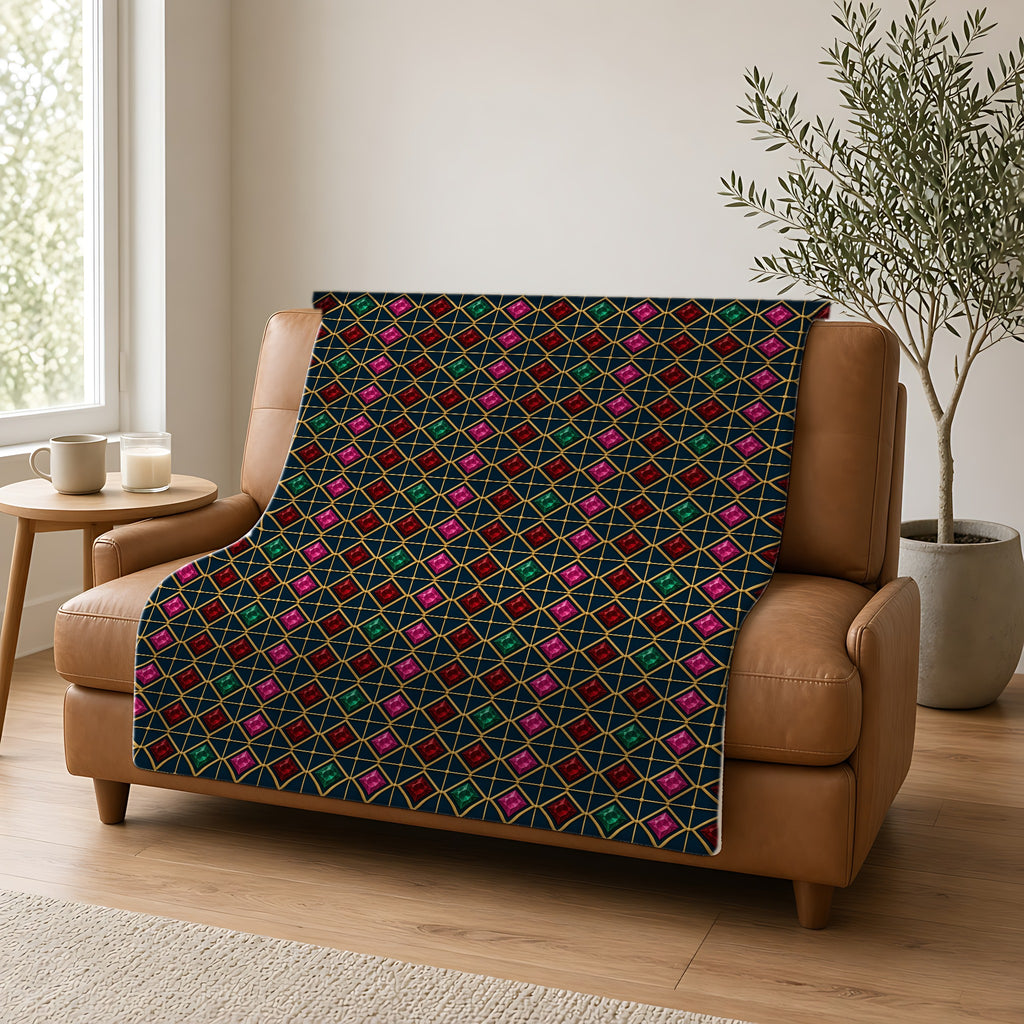 Gold Diamond Trellis Sherpa Fleece Blanket draped over a caramel leather sofa