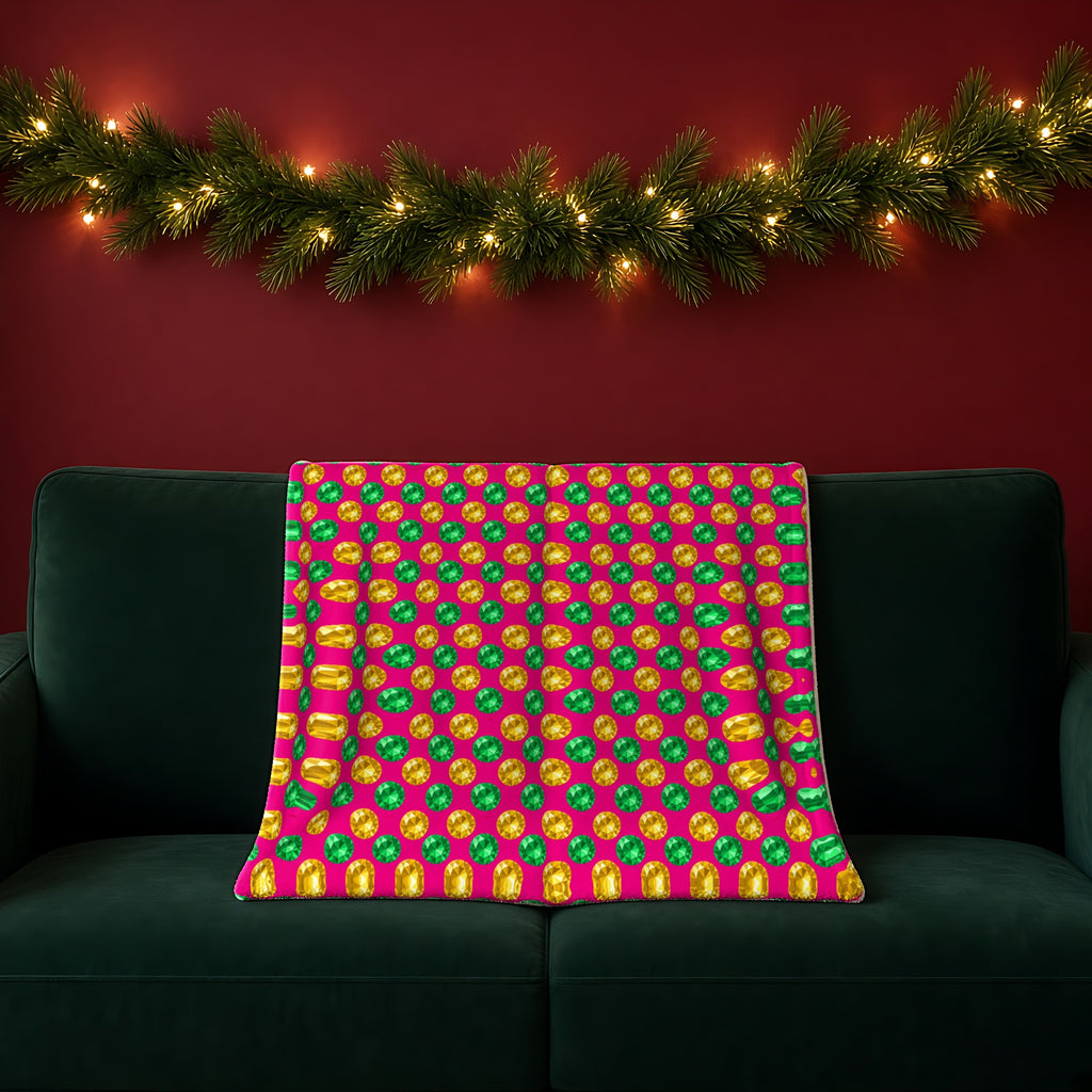 Half-Drop Gem Grid sherpa fleece blanket in the Festive Jewel Bright palette, draped over a green sofa in a festive room with a garland and fairy lights