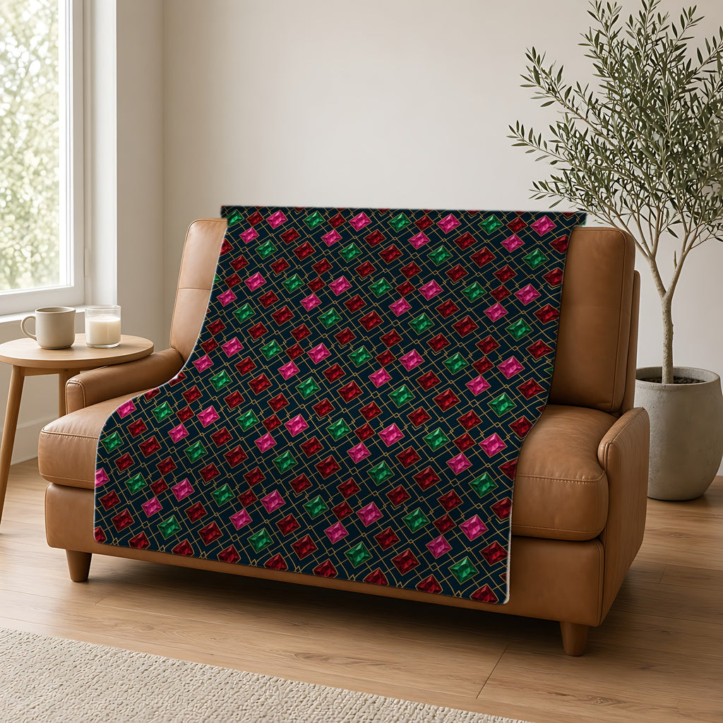 Jewel Argyle Sherpa Fleece Blanket draped over a caramel leather sofa