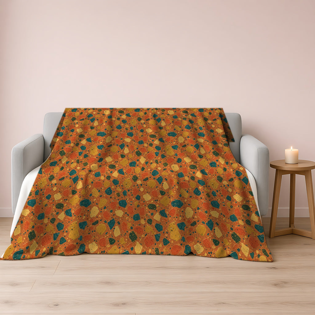 Macro Chip Mix Sherpa Fleece Blanket draped over a grey sofa