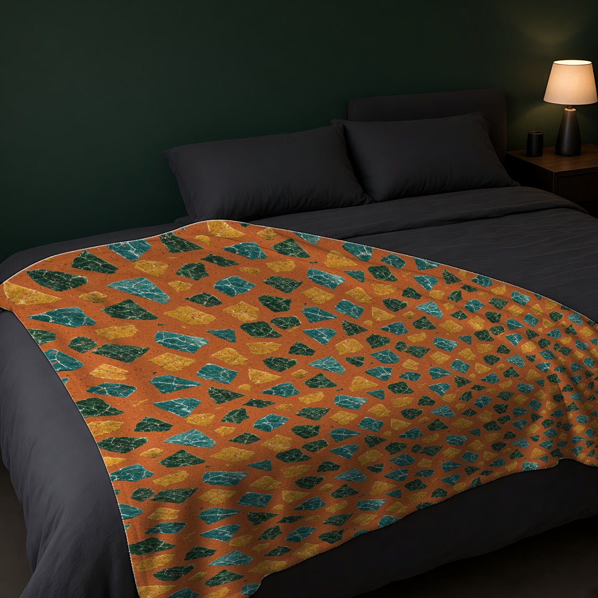 Marble Fragment Toss Sherpa Fleece Blanket across the foot of a dark bed