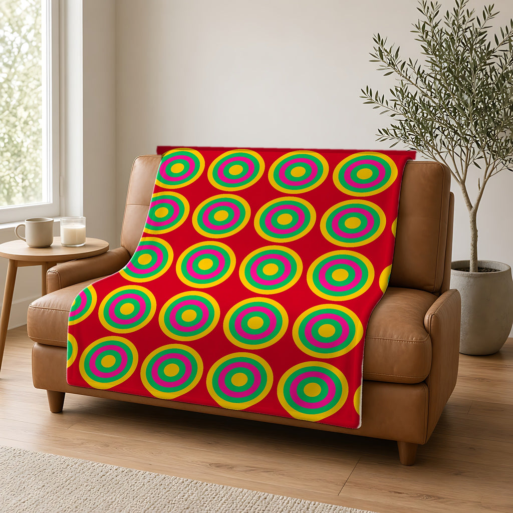 Mega Ring Grid Sherpa Fleece Blanket draped over a caramel leather sofa